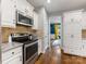 View of the kitchen featuring granite countertops, stainless steel appliances, and white cabinets at 15313 Moate Ct, Huntersville, NC 28078