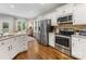 Well-lit kitchen with stainless steel appliances, granite countertops, and adjacent breakfast area at 15313 Moate Ct, Huntersville, NC 28078