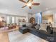 Open-concept living room with a sofa and dining area that flows into a kitchen with stainless steel appliances at 15313 Moate Ct, Huntersville, NC 28078
