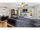Comfortable living room featuring a fireplace, a large sofa, a ceiling fan, and natural light at 15313 Moate Ct, Huntersville, NC 28078