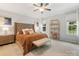 Main bedroom with tufted headboard, accent pillows, and large windows at 15313 Moate Ct, Huntersville, NC 28078