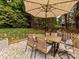 Outdoor patio with modern table and chairs beneath a large umbrella, perfect for entertaining at 15313 Moate Ct, Huntersville, NC 28078