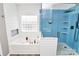 Bright bathroom with a separate tub and shower featuring blue tiling at 1618 Bay Meadows Nw Ave, Concord, NC 28027