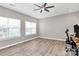 Bright bedroom with hardwood floors, ceiling fan, and large windows at 1618 Bay Meadows Nw Ave, Concord, NC 28027