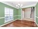 Open dining room view featuring a hardwood floor, and views into the home entry and staircase at 1618 Bay Meadows Nw Ave, Concord, NC 28027