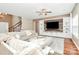 Cozy living room featuring a built-in entertainment center and a plush sectional sofa at 1618 Bay Meadows Nw Ave, Concord, NC 28027