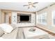 Bright living room with a large entertainment center, neutral tones and hardwood floors at 1618 Bay Meadows Nw Ave, Concord, NC 28027