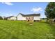 Spacious backyard with a stone fire pit and a wooden deck at 170 Wagon Wheel Way # 4, Salisbury, NC 28147