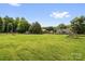 Wide backyard with a playground, fire pit, and lush greenery at 170 Wagon Wheel Way # 4, Salisbury, NC 28147