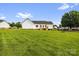 Large backyard featuring a well-maintained lawn, deck, and mature trees at 170 Wagon Wheel Way # 4, Salisbury, NC 28147