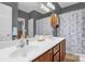 Bathroom featuring double sinks, vanity, and shower/tub with blue floral curtain at 170 Wagon Wheel Way # 4, Salisbury, NC 28147
