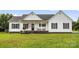 Charming ranch-style home with white siding, dark shutters, and a welcoming front porch with rocking chairs at 170 Wagon Wheel Way # 4, Salisbury, NC 28147