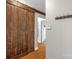 Hallway with barn door, wooden floors, and coat rack at 170 Wagon Wheel Way # 4, Salisbury, NC 28147