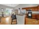 Eat-in kitchen featuring breakfast bar seating, stainless steel appliances, and wood cabinets at 170 Wagon Wheel Way # 4, Salisbury, NC 28147