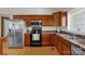 Functional kitchen featuring stainless steel refrigerator and modern appliances, plus ample wood cabinets at 170 Wagon Wheel Way # 4, Salisbury, NC 28147