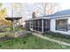 Well-maintained backyard with a screened-in porch, stone pathway and a charming porch swing for relaxing outdoors at 1770 Windsor Dr, Lancaster, SC 29720
