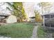 Spacious backyard with lush green lawn, utility shed, stone pathways, and a swing beneath the shade of mature trees at 1770 Windsor Dr, Lancaster, SC 29720