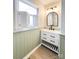 Bathroom featuring modern vanity with storage and black hardware, complemented by stylish window shutters at 1770 Windsor Dr, Lancaster, SC 29720