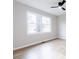 Bedroom with light hardwood floors, neutral paint, and large window overlooking the yard at 1770 Windsor Dr, Lancaster, SC 29720