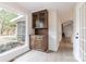 Bright dining area featuring built-in cabinets and a large window overlooking the serene backyard at 1770 Windsor Dr, Lancaster, SC 29720