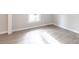 Empty room featuring neutral paint, a window, and wood-look floors at 1770 Windsor Dr, Lancaster, SC 29720