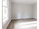 Empty room with neutral paint, a window, and wood-look floors at 1770 Windsor Dr, Lancaster, SC 29720