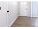 Entryway features neutral paint, wood-look floors, and white door with black hardware at 1770 Windsor Dr, Lancaster, SC 29720