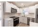 Modern kitchen with stainless steel appliances, white cabinets, and quartz countertops at 1770 Windsor Dr, Lancaster, SC 29720