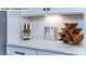Representative photo shows modern white kitchen counter and white tiled backsplash with wine storage at 180 Asmodean Ln, Troutman, NC 28166