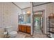 Bright bathroom featuring vanity, sink, a classic toilet, and floral wallpaper for a vintage aesthetic at 18070 Old Beatty Ford Rd, Gold Hill, NC 28071
