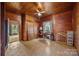 Rustic bedroom features wood paneled walls, closet storage, and natural light, creating a warm retreat at 18070 Old Beatty Ford Rd, Gold Hill, NC 28071