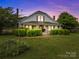 Charming two-story home featuring a covered front porch and meticulously maintained landscaping at 18070 Old Beatty Ford Rd, Gold Hill, NC 28071