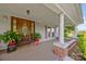 Charming front porch with a decorative wood door and brick accents at 18070 Old Beatty Ford Rd, Gold Hill, NC 28071
