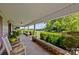 Inviting covered front porch with rocking chairs and views of the landscaped yard at 18070 Old Beatty Ford Rd, Gold Hill, NC 28071