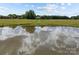 A pond reflects the sky on a large lot with a home in the distance at 18070 Old Beatty Ford Rd, Gold Hill, NC 28071