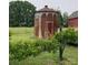 Vintage silo and barn amidst lush greenery, evoking a sense of rustic charm and history at 18070 Old Beatty Ford Rd, Gold Hill, NC 28071