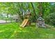 Manicured backyard area with a playground, swing set, and playhouse at 2045 10Th Street Nw Ln, Hickory, NC 28601