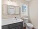 Well-lit bathroom with a modern vanity, a large mirror, and a view to the outside at 2045 10Th Street Nw Ln, Hickory, NC 28601