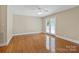 Spacious bedroom with hardwood floors, a ceiling fan, and glass doors leading to an outdoor balcony at 2045 10Th Street Nw Ln, Hickory, NC 28601