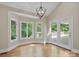 Sunlit dining area featuring hardwood floors, vaulted ceilings, and access to a private outdoor deck at 2045 10Th Street Nw Ln, Hickory, NC 28601