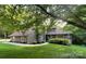 Charming home with wood siding, manicured lawn, and mature trees offering curb appeal at 2045 10Th Street Nw Ln, Hickory, NC 28601