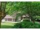 Beautiful home with a manicured lawn, stone accents, and mature trees providing shade and privacy at 2045 10Th Street Nw Ln, Hickory, NC 28601
