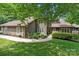 Charming two-story home features a manicured lawn, stone accents, and lush landscaping at 2045 10Th Street Nw Ln, Hickory, NC 28601