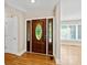 The foyer features hardwood floors and a beautiful wooden door with decorative glass inserts at 2045 10Th Street Nw Ln, Hickory, NC 28601
