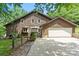 Charming home featuring a two-car garage, lush landscaping, and a welcoming covered front porch at 2045 10Th Street Nw Ln, Hickory, NC 28601