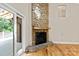Living room featuring a stone fireplace with wood mantel, hardwood floors and natural light at 2045 10Th Street Nw Ln, Hickory, NC 28601