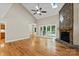 Spacious living room featuring hardwood floors, a stone fireplace, vaulted ceilings, and natural light at 2045 10Th Street Nw Ln, Hickory, NC 28601