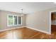 Bright room featuring hardwood floors, a modern chandelier, and a large window with natural light at 2045 10Th Street Nw Ln, Hickory, NC 28601