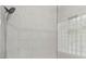 Contemporary shower with marble tiles, glass enclosure, and window at 2045 10Th Street Nw Ln, Hickory, NC 28601