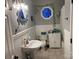 Charming bathroom with decorative mirror, a pedestal sink, and beadboard paneling, creating a cozy space at 208 Stone Ridge Dr, Salisbury, NC 28146